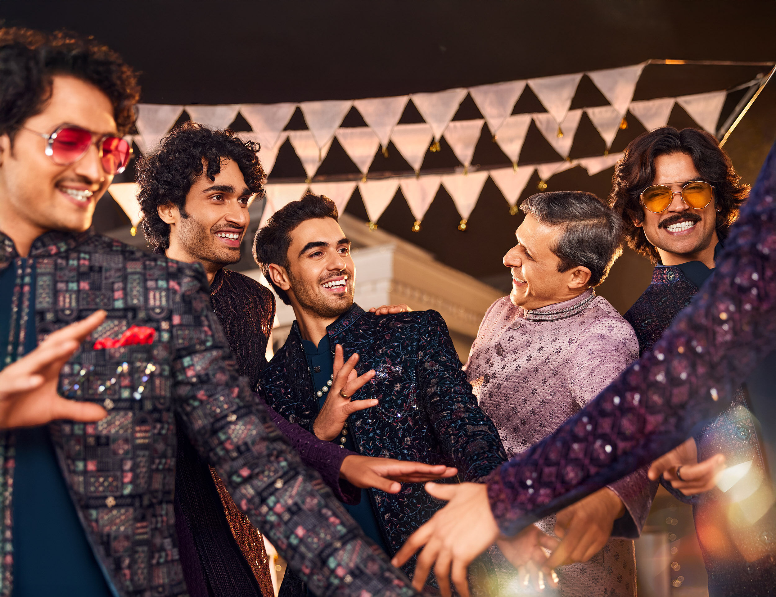 groom annd groomsmen wearing indo western sherwani and dancing on wedding reception